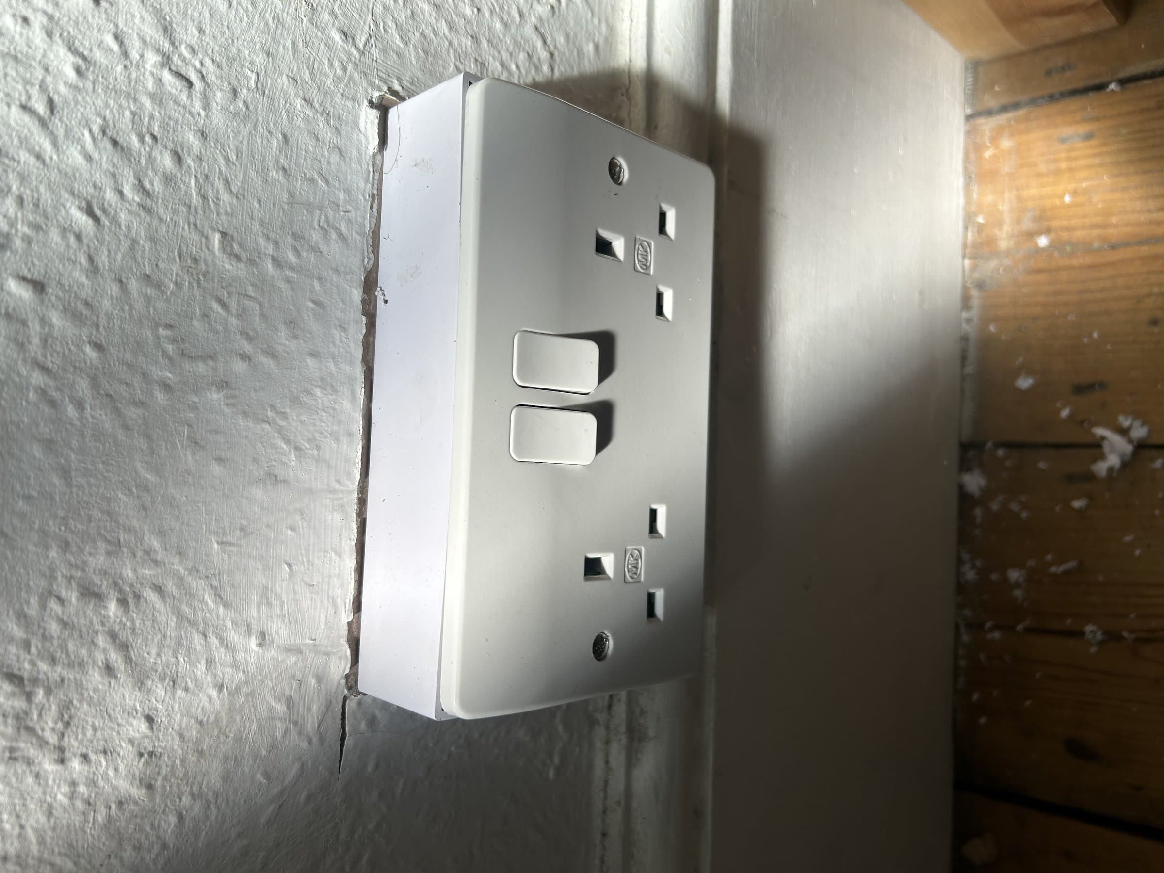 New double socket and switch faceplate fitted flush to the wall