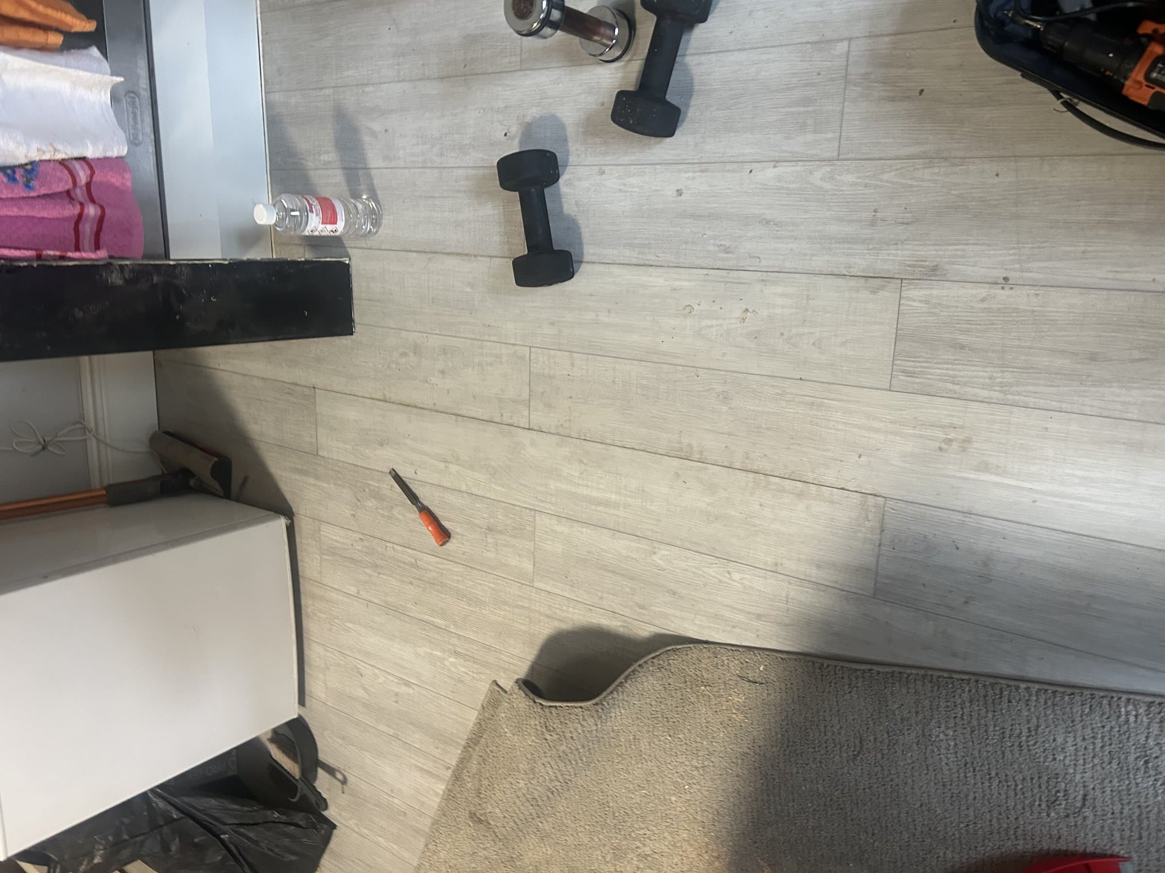 Newly replaced grey wood-effect laminate flooring, fully laid and finished